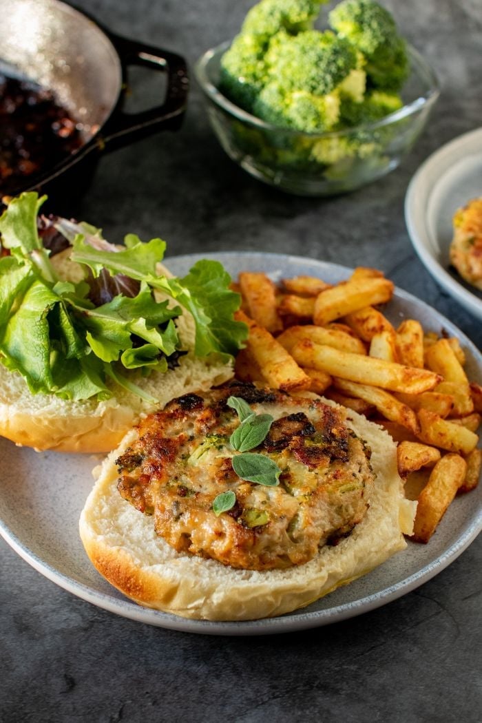 chicken fritter on a bun with French fries